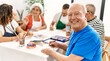 © Krakenimages.com - Group of middle age draw students sitting on the table drawing at art studio. Man smiling happy looking to the camera.