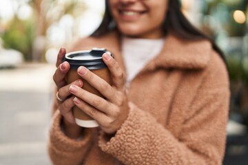 Poster - Young hispanic woman smiling confident drinking coffee at street