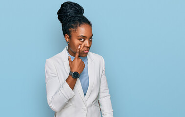 Sticker - Young african american woman wearing business clothes pointing to the eye watching you gesture, suspicious expression