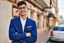 Young Man Smiling Confident Wearing Suit And Glasses At Street