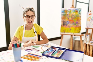 Sticker - Young brunette teenager at art studio angry and mad screaming frustrated and furious, shouting with anger. rage and aggressive concept.