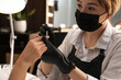 Professional manicurist working with client in salon, closeup. Beauty services during Coronavirus quarantine