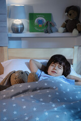 Wall Mural - Cute little boy with toy bunny sleeping in bed at home