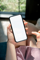 Wall Mural - closeup female hands using smartphone at home. blank screen mobile phone for graphic display montage