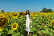 woman walking and enjoying with sunflower field