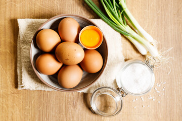 Wall Mural - brown eggs in a bowl on wooden table..