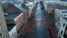 Bethlehem Pennsylvania Decorated At Christmas. Moravian Star Painted On Road. Rising Aerial.