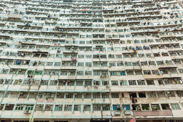 Exterior of crowded hig rise residential building in Hong Kong city