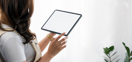 Fototapete - Mockup image of young woman holding digital tablet with blank  white screen, isolated on white background.
