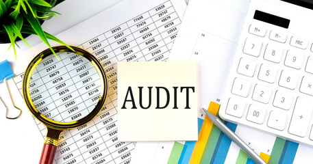 Poster - AUDIT text on sticker on diagram with magnifier and calculator. Business concept