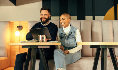 Happy businesspeople working together in an office lobby