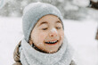 © Bostan Natalia - Closeup portrait of a little boy with snow on his nose, laughing, with eyes closed, on cold winter day.