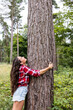 © Westend61 - Woman hugging tree looking up at Cannock Chase