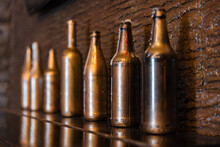 Bottles Covered With Golden Paint Stand In A Row