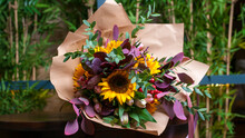 Photo Of A Bouquet Of Sunflowers On The Table.