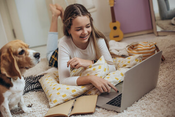 teenage girl with a laptop in her room. high quality photo