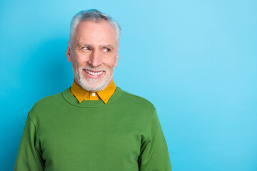 Sticker - Photo of dreamy retired man wear green sweater looking empty space isolated blue color background