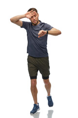 Poster - fitness, sport and healthy lifestyle concept - tired man in sports clothes looking at his smart watch or tracker running over white background