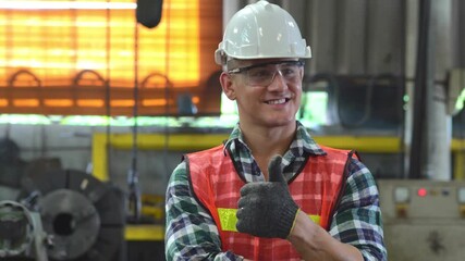 Wall Mural - Portrait of confident engineer foreman in arms crossed showing thumbs up and smiling to camera at the industrial factory. blue collar worker at construction site