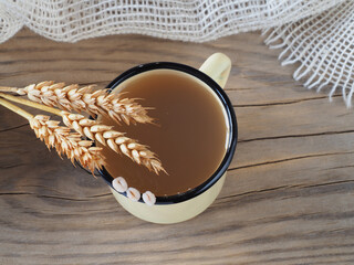 Wall Mural - Natural drink with pearl barley, raw seeds, spikelets on a wooden table, flat layout, top view, closeup. Job's tears agricultural crop for use in dietary, vegetarian and vegan nutrition