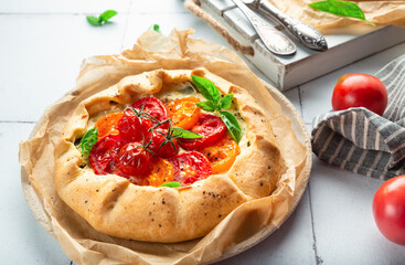 Sticker - Fresh homemade galette with tomatoes, ricotta cheese and basil on white tile background.