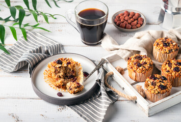 Wall Mural - Fresh homemade oatmeal muffins with dried cranberry on white wooden tray. Healthy gluten free dessert.