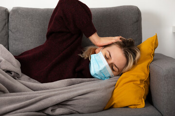 Wall Mural - Sick woman with protective mask at home