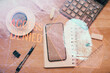 © peshkova - Double exposure of finger print over table with phone. Top view. Concept of mobile security.