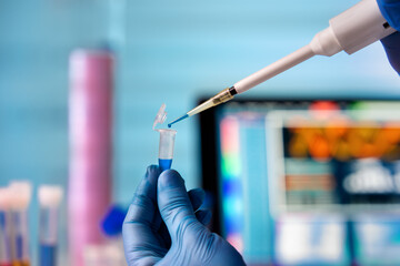 Wall Mural - engineer genetic working with pipette and fluids in research laboratory. Scientist dripping a sample into a test tube in biochemical lab