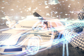 Poster - Double exposure of man's hands holding and using a digital device and automobile theme hologram drawing. Technology concept.