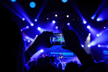 Taking pictures with a smartphone during a concert.