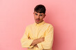 © Asier - Young mixed race man isolated on pink background who is bored, fatigued and need a relax day.