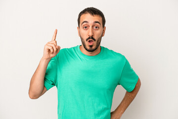 Young caucasian man isolated on white background having an idea, inspiration concept.