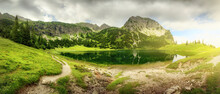 Panoramic Scenery Around A Mountain Lake With Dramatic Sunlight 