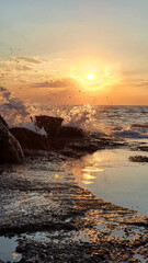 Wall Mural - colorful sunset with large sun under the sea waves.