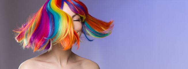 woman hair as color splash. rainbow up do short haircut. beautiful young girl model with glowing hea