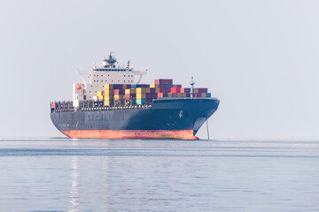 Wall Mural - A cargo ship delivers a lot of containers with goods from China. Sea shipment and transportation industry