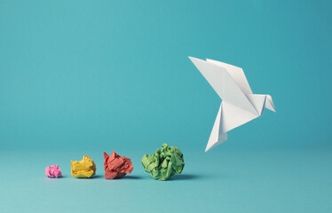 colorful crumpled paper balls with a paper dove, peace, freedom or opportunities