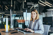 © Liubomir - Happy and successful business woman working in the office at the computer rejoices in good results, successful employee and boss