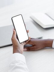 Gadget advertising. Phone network. Mobile app. Website mockup. Unrecognizable woman hand using cell white screen copy space at desk workplace.
