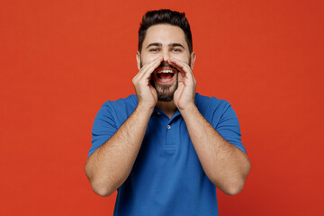 Wall Mural - Young smiling happy caucasian man 20s wear basic blue t-shirt scream hot news about sales discount with hands near mouth isolated on plain orange background studio portrait. People lifestyle concept.