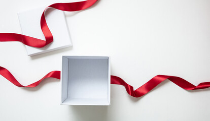 Wall Mural - valentine day gift, open white box and red satin ribbon isolated on white, empty space.