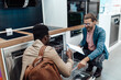 © hedgehog94 - African American man choosing dishwasher in electronics and appliances store.