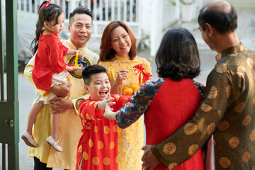 Wall Mural - Excited kid happy to visit his grandparents for Chinese New Year family reunion