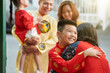 © DragonImages - Excited smiling preteen boy hugging grandmother when his family visiting granparents for Tet celebration