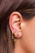 Woman ear with mulriple piercings wearing beautiful earrings with zirconia.  Beautiful valentine's gift.
