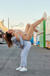 © Cavan Images - Two women friends have a good time at a funfair at sunset
