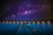 Night time long exposure landscape, over water villas in Maldives. Amazing sunset panorama at Maldives. Luxury resort villas seascape with soft led lights under colorful sky. Fantastic nature scenic