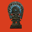 a decorative mayan statuette isolated on a red background