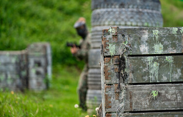 Wall Mural - woman in uniform with a gun in military paintball training